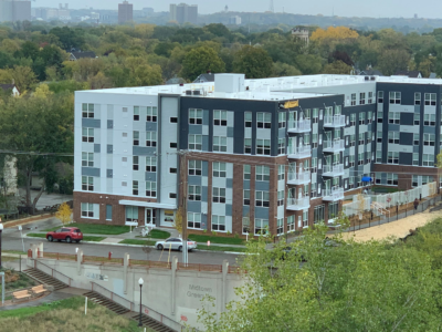 Image of multi-level apartment development, Midwell Apartments with view from Allina Health campus