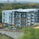 Image of multi-level apartment development, Midwell Apartments with view from Allina Health campus