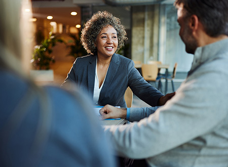 Female executive having a business meeting with two people.