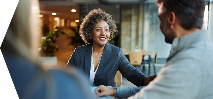 Female executive having a business meeting with two people.