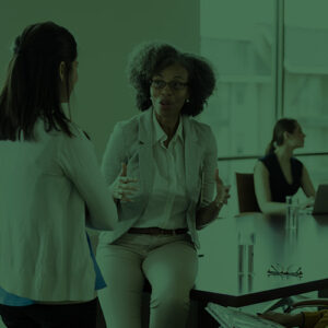Businesswomen having a discussion in an office.