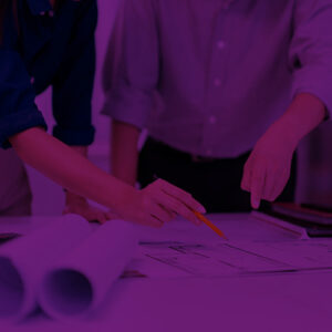 Two people review architectural plans.
