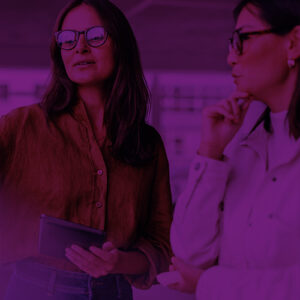 Two business women in discussion in an office.