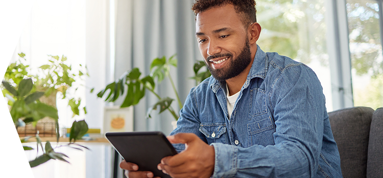 Man sitting in an office reading a tablet