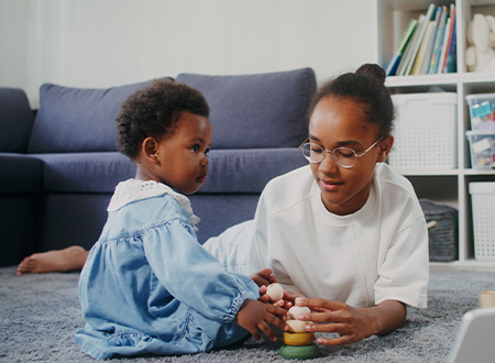 Two sisters at play in their living room