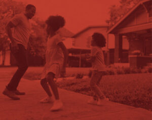 Man and kids playing on sidewalk