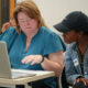 Two women looking at computer