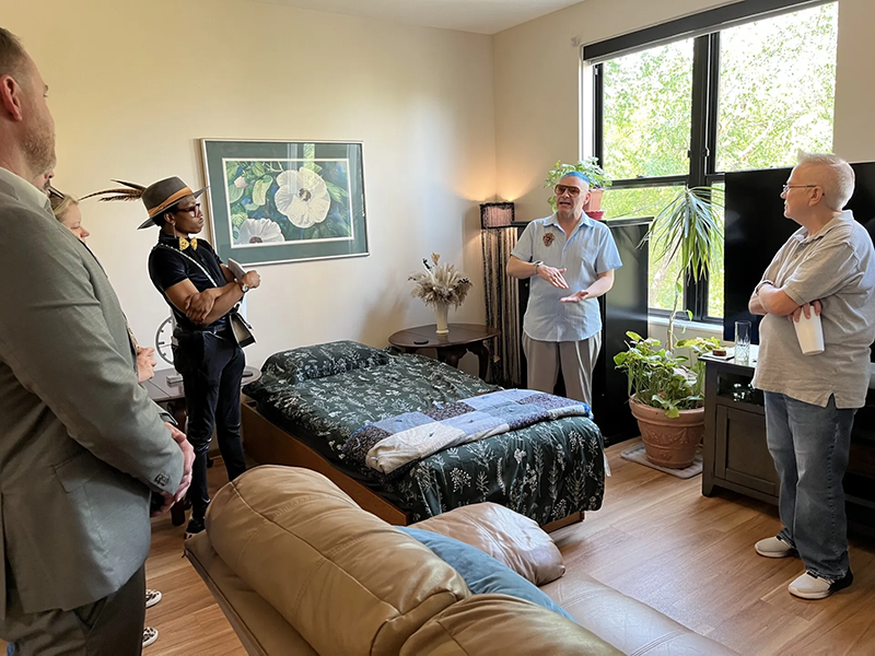 Marty, a resident of Clare Housing, gives a tour of his new apartment during the grand opening event