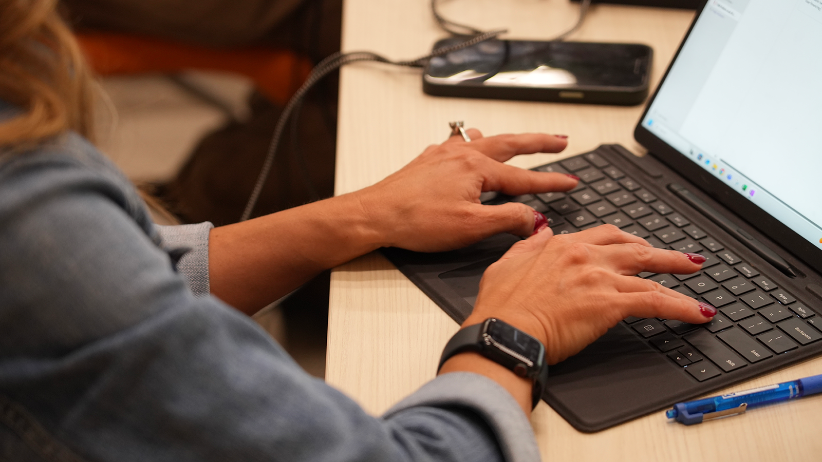 Women typing on a laptop during a training